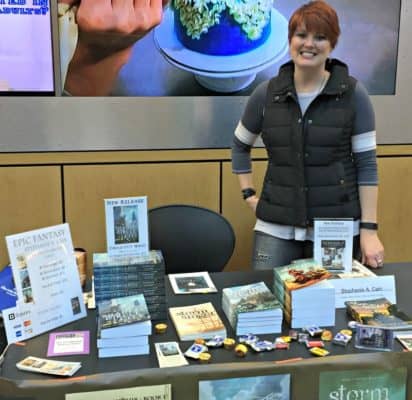 Self-publishing panelist Stephanie A. Cain stands at her table at the Allen County Public Library 2016 Author Fair