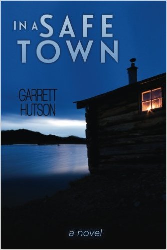 Cover of mystery novel "In a Safe Town" by Garrett Hutson, this features a lake and a cabin under a cloudy sky