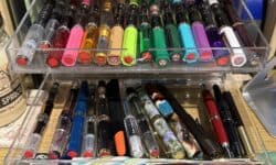 Two clear acrylic drawers full of colorful fountain pens, half of which are TWSBI Eco pens.
